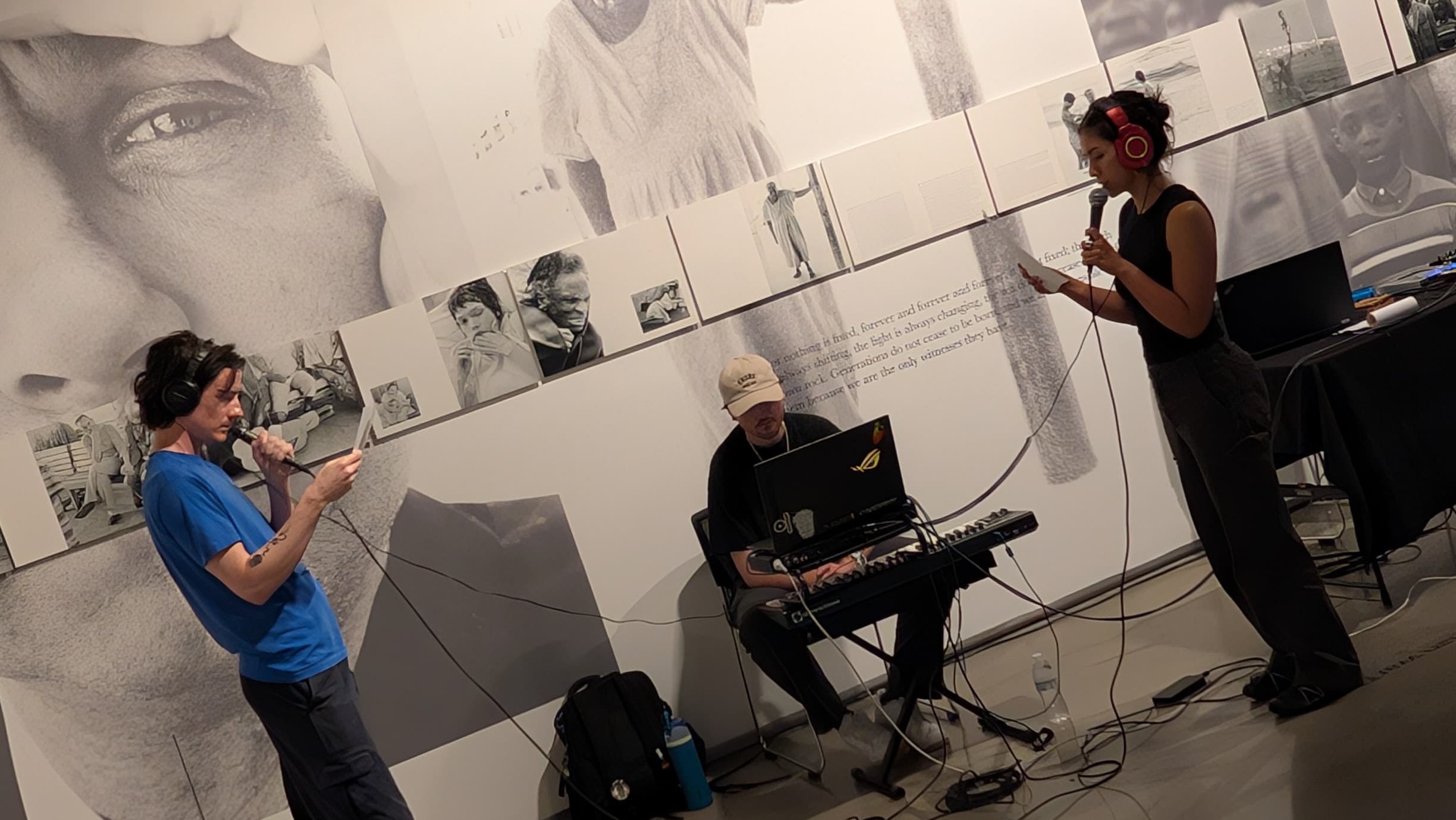 Performers reading from prepared scripts into microphones during The Encryption Ritual